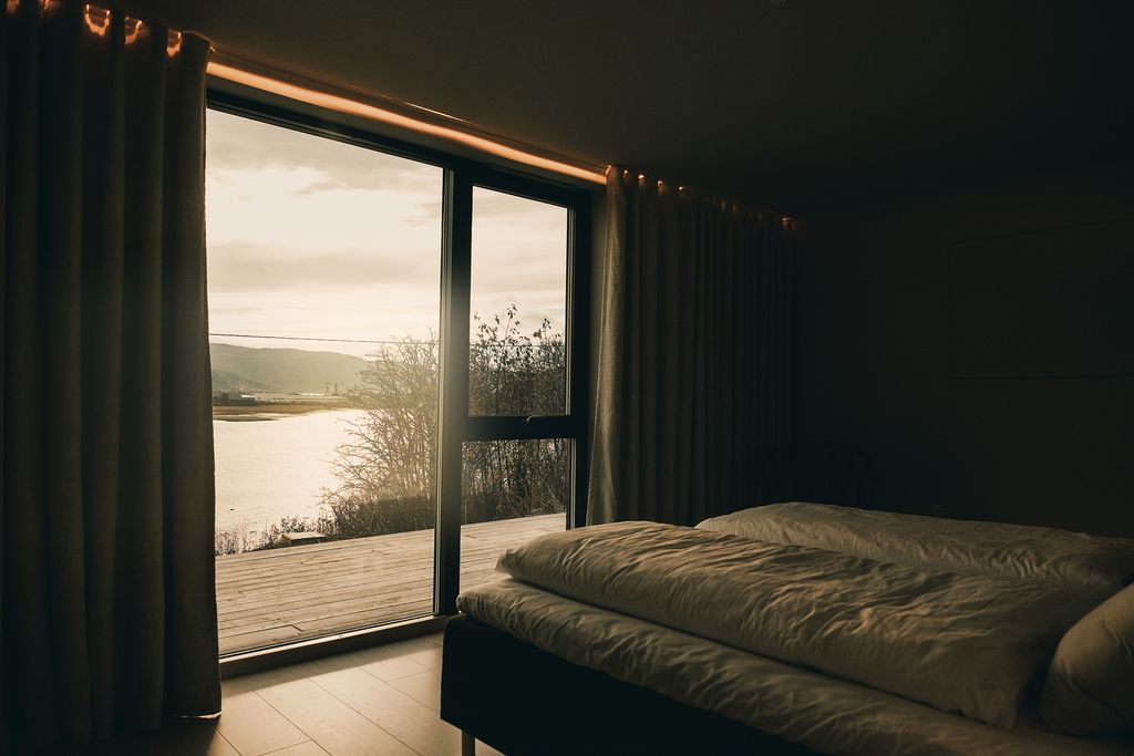 Bedroom in evening light, with a view over the fjord