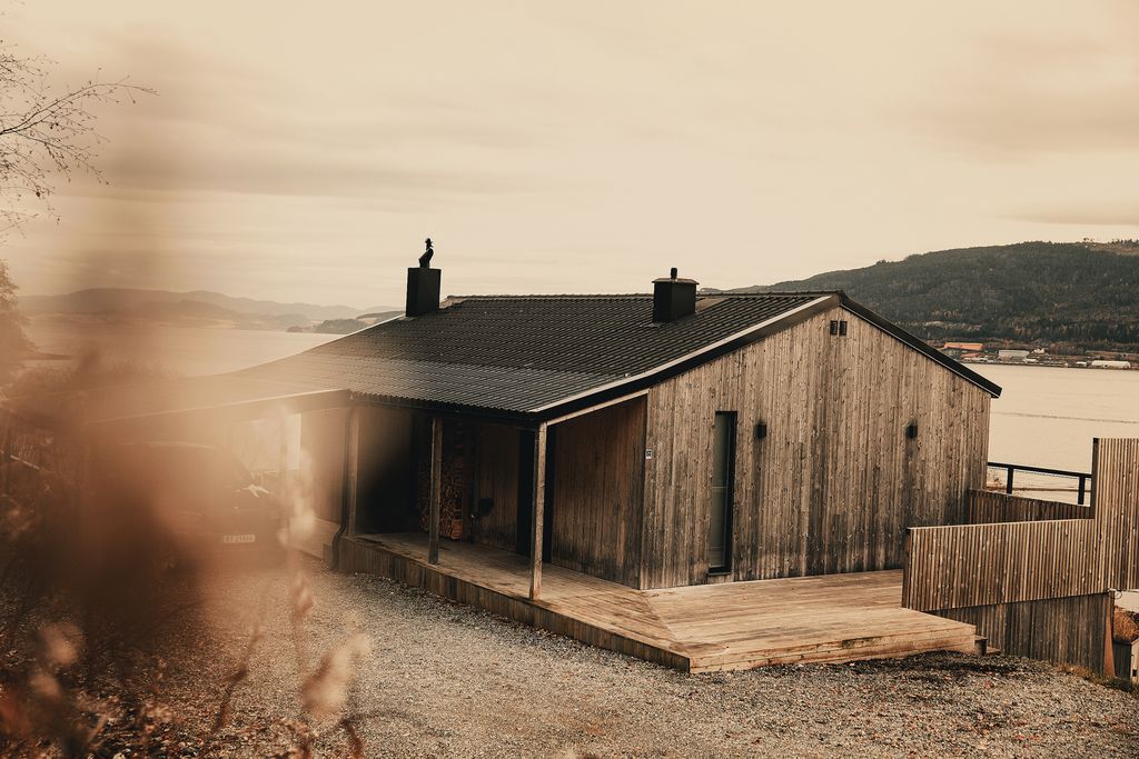 A timber house above the fjord near Orkanger, seen through autumn grass